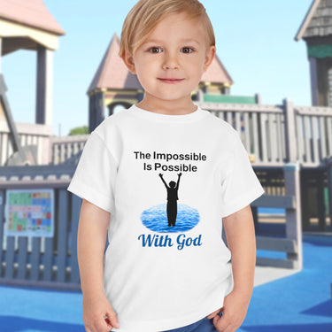 Bella+Canvas toddler t-shirt with “Impossible Toddler” design and faith-filled message, soft cotton, breathable and durable, Christian apparel for active toddlers and family matching, toddler boy in white t-shirt